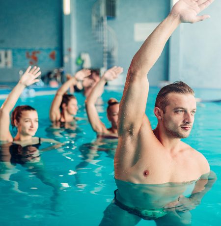 Aqua aerobics in water sport center, indoor swimming pool, recreational leisure